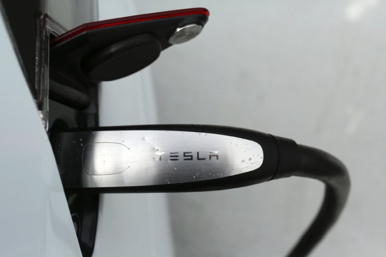A Tesla Model S is charged at a Tesla Motors dealership at Corte Madera Village, an outdoor retail mall, in Corte Madera