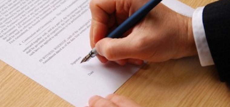 male hand keeping an elegant pen and sihning a contract